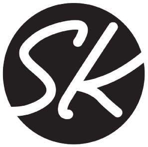 Logo for SheKeeps, a travel and arts blog